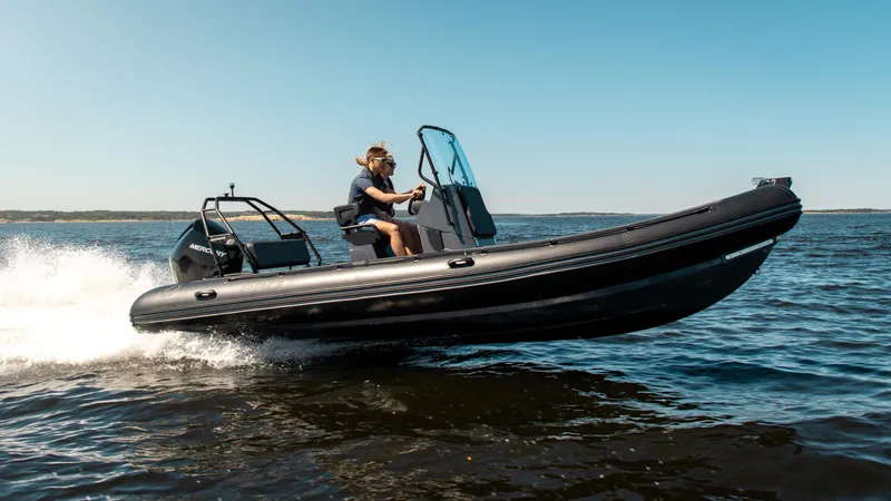 Slide: The Image of 2025 Zodiac Pro 7 boat speeding on open water under clear blue sky. - 4