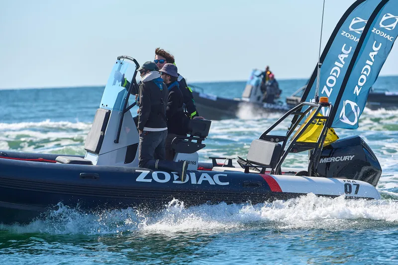 Slide: The Image of 2025 Zodiac Pro 7 boat navigating ocean waves with passengers onboard. - 6