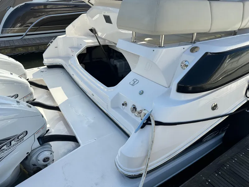 Slide: The Image of 2021 Regal 42 FXO boat with dual outboard engines at dock. - 11