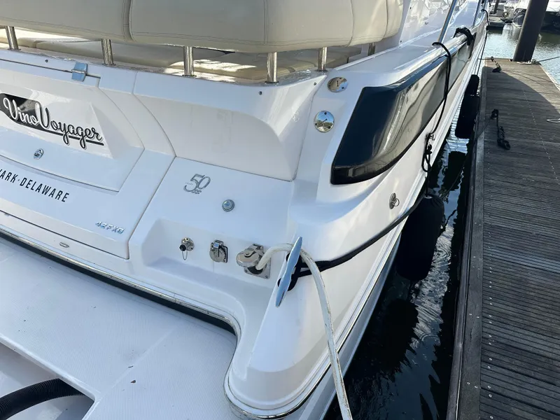 Slide: The Image of 2021 Regal 42 FXO yacht docked, rear view showing sleek design and branding. - 13