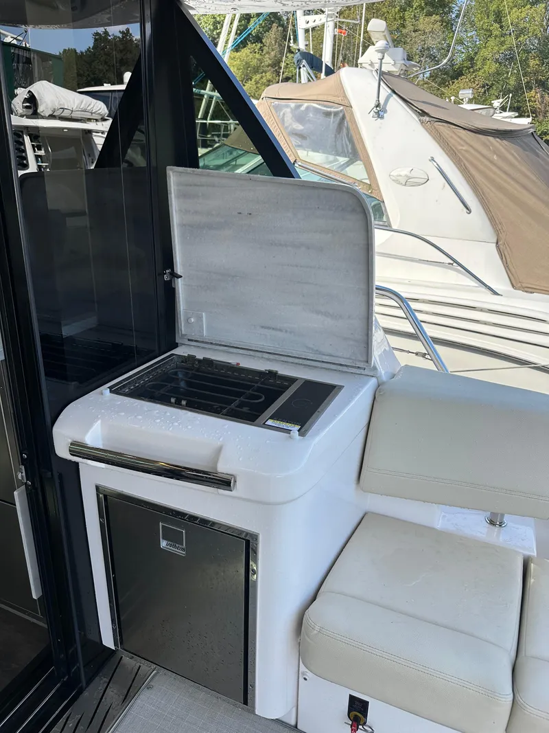 Slide: The Image of 2021 Regal 42 FXO yacht with outdoor kitchenette and seating area. - 17