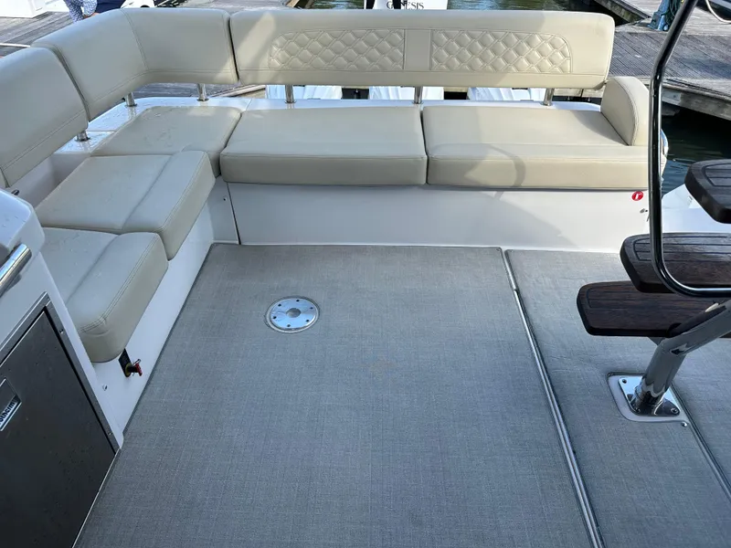 Slide: The Image of Luxurious seating area on 2021 Regal 42 FXO yacht, featuring beige upholstery and spacious layout. - 18