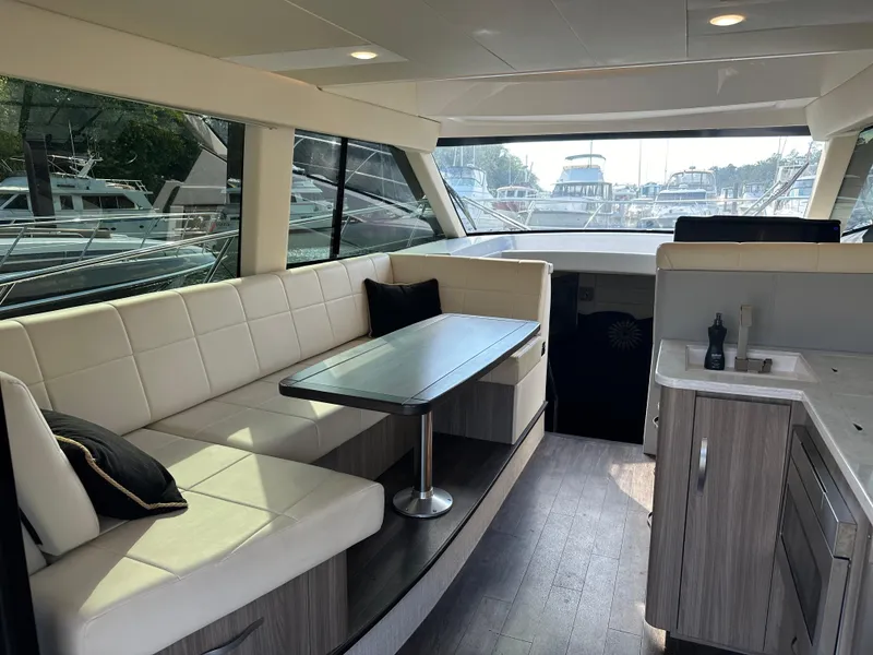 Slide: The Image of Interior of 2021 Regal 42 FXO yacht with modern seating and dining area. - 19