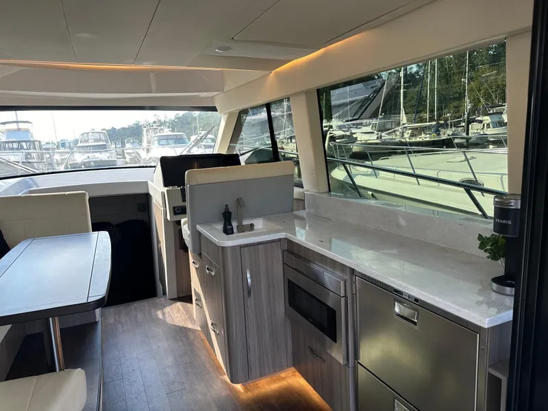Slide: The Image of Interior of 2021 Regal 42 FXO yacht with modern kitchen and dining area. - 20