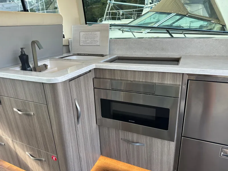 Slide: The Image of Modern kitchen area in 2021 Regal 42 FXO yacht with sleek cabinetry and appliances. - 21