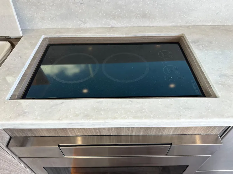 Slide: The Image of Built-in stovetop on 2021 Regal 42 FXO yacht kitchen counter. - 22