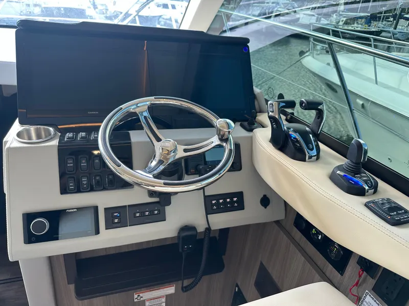 Slide: The Image of Helm of 2021 Regal 42 FXO yacht with modern controls and navigation equipment. - 24