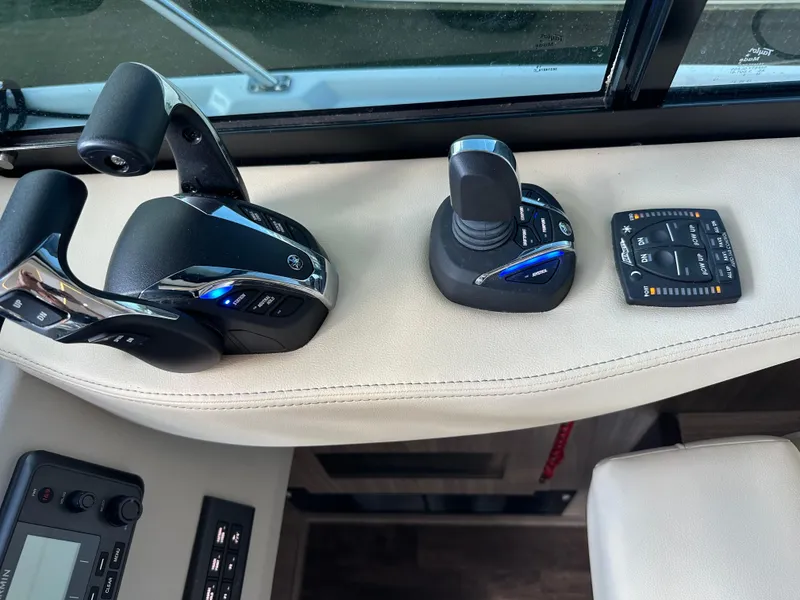 Slide: The Image of Control panel of 2021 Regal 42 FXO boat with throttle and joystick. - 25