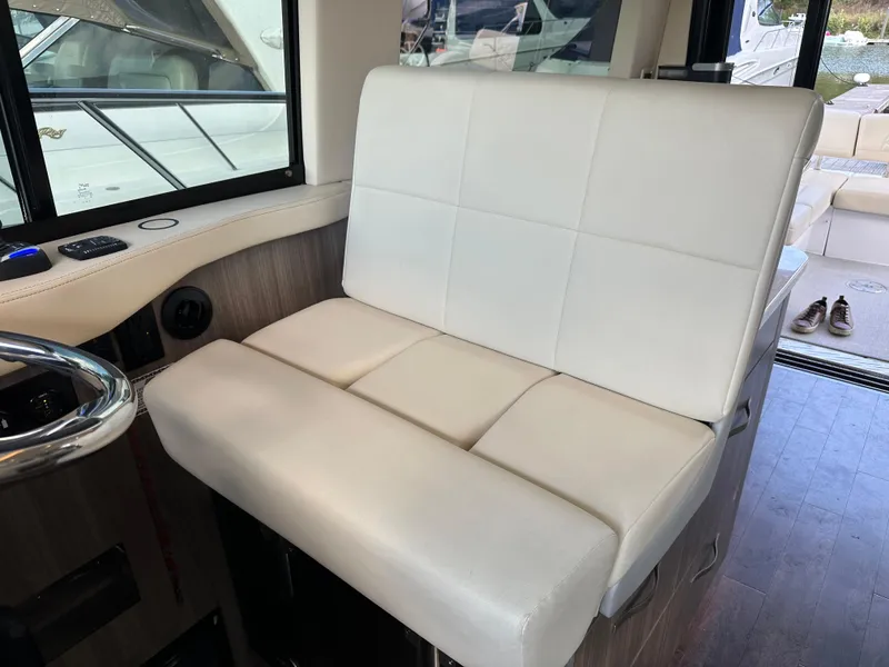 Slide: The Image of White leather seating in 2021 Regal 42 FXO boat interior. - 26