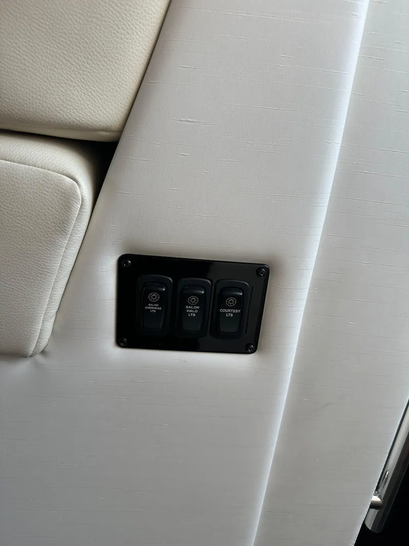 Slide: The Image of 2021 Regal 42 FXO interior with control panel on white upholstery. - 28