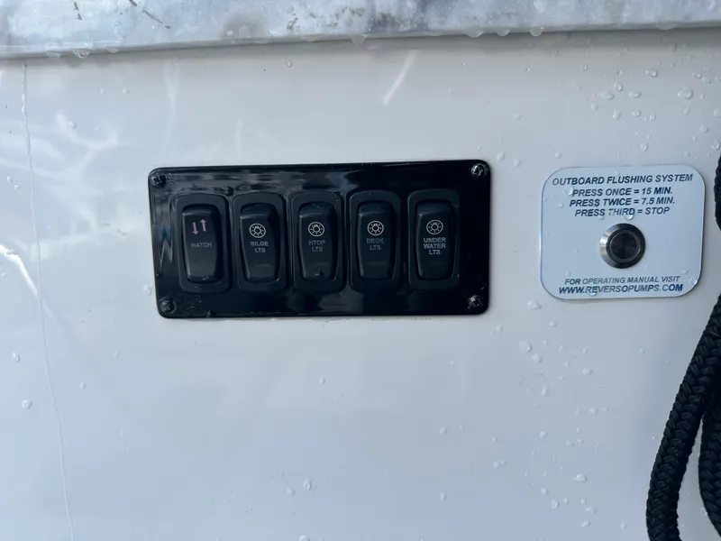 Slide: The Image of Control panel on a 2021 Regal 42 FXO boat with outboard flushing system instructions. - 29