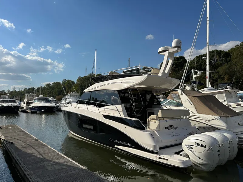 Slide: The Image of 2021 Regal 42 FXO yacht docked at marina with Yamaha engines. - 3