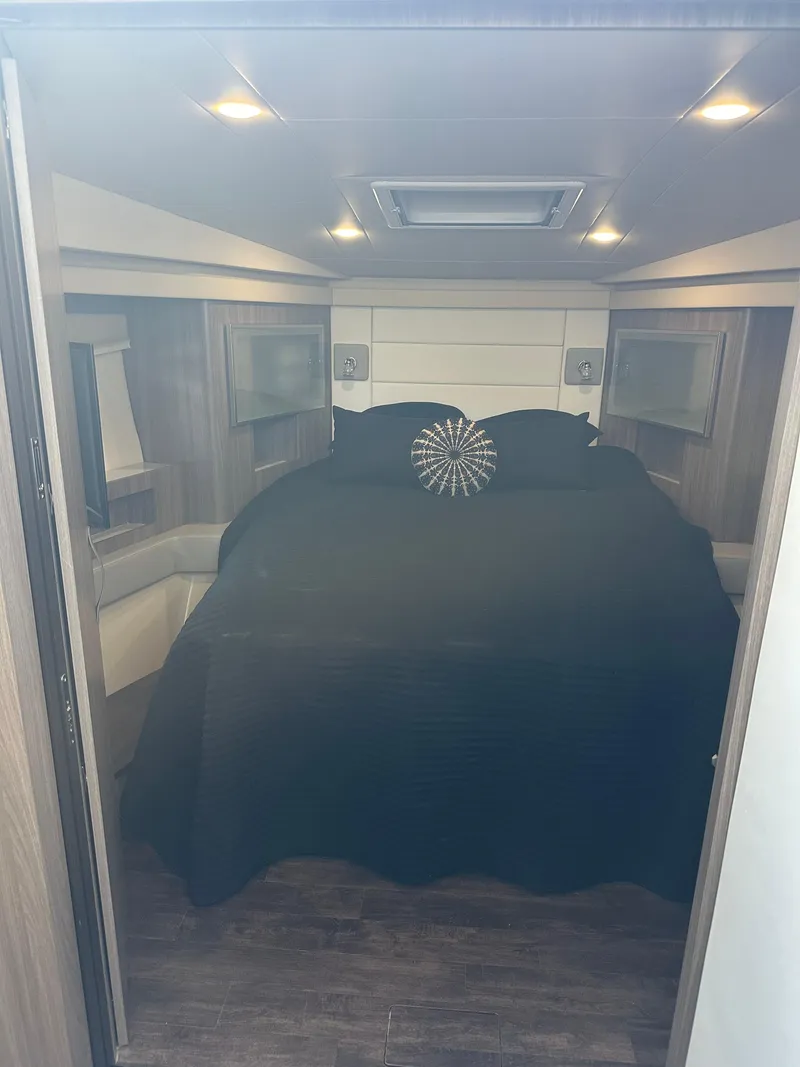 Slide: The Image of Interior cabin of 2021 Regal 42 FXO with cozy bed and modern lighting. - 30