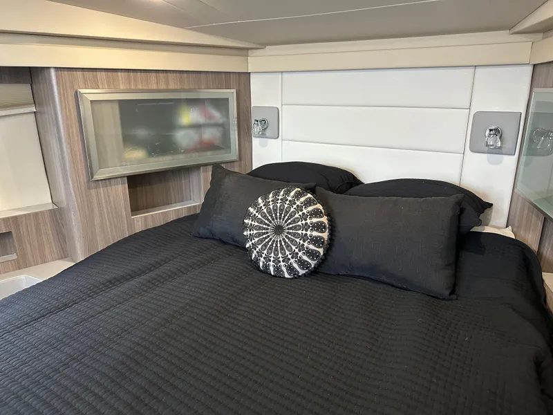 Slide: The Image of Luxurious bedroom interior of 2021 Regal 42 FXO yacht with modern design and black bedding. - 32