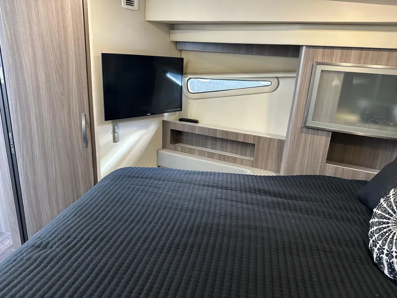 Slide: The Image of Interior cabin of 2021 Regal 42 FXO yacht with TV and modern furnishings. - 33