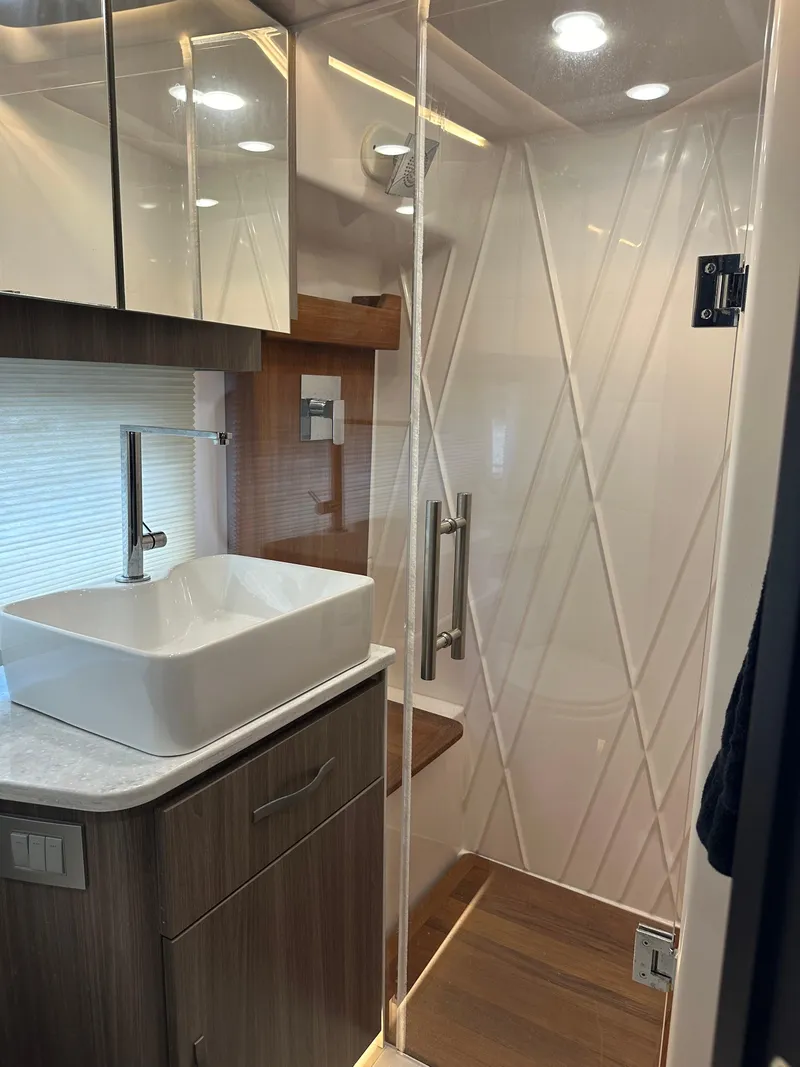 Slide: The Image of Modern bathroom interior in 2021 Regal 42 FXO yacht with sleek design and glass shower. - 36
