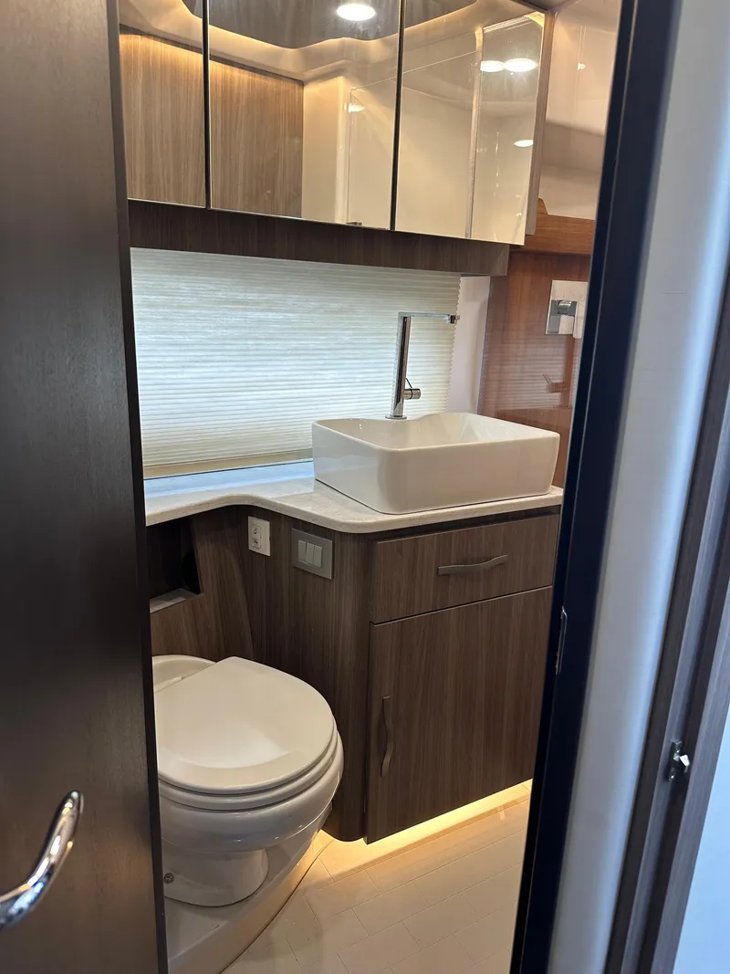 Slide: The Image of Luxurious bathroom in 2021 Regal 42 FXO yacht with modern fixtures and wood cabinetry. - 37