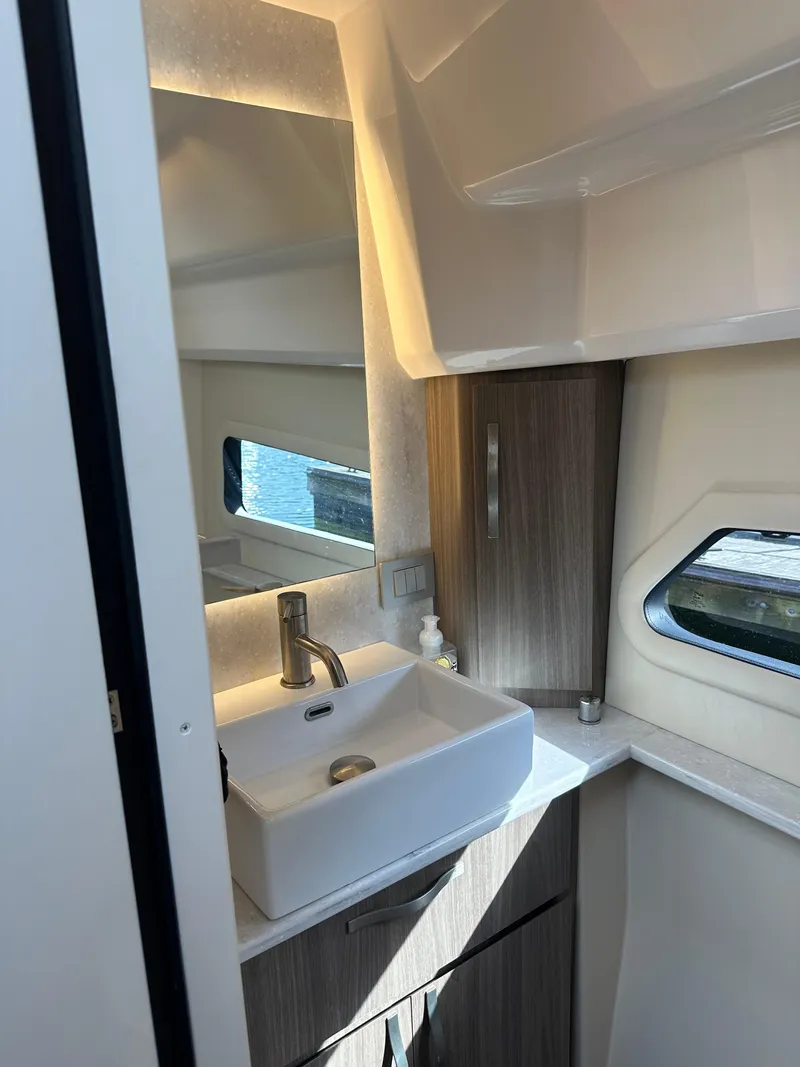 Slide: The Image of 2021 Regal 42 FXO yacht bathroom with modern sink and window. - 39