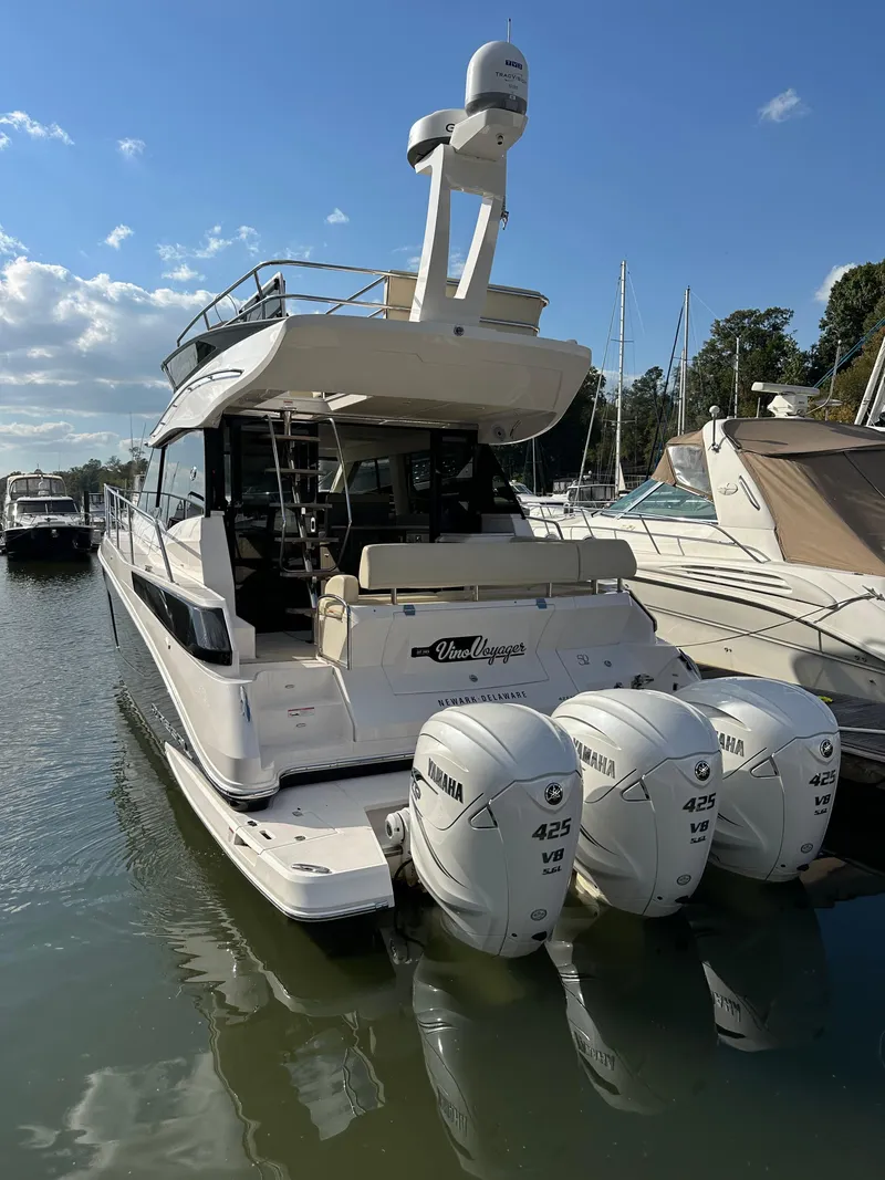 Slide: The Image of 2021 Regal 42 FXO yacht with triple Yamaha 425 engines docked at marina. - 4