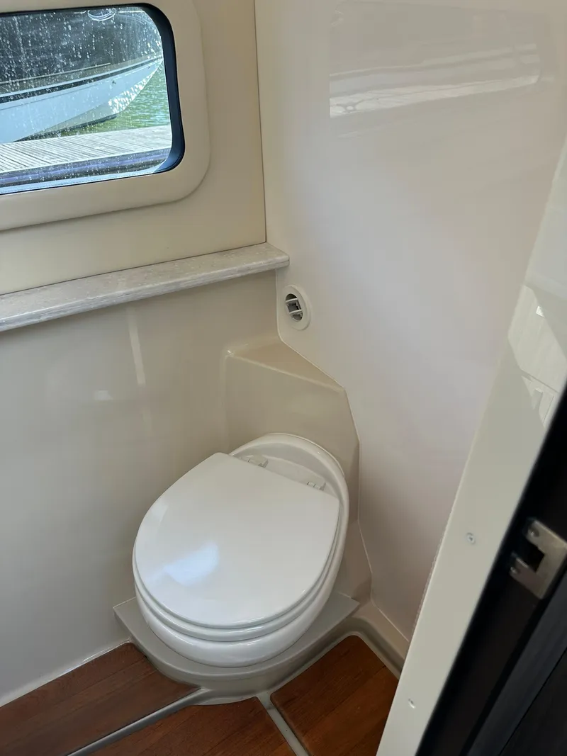 Slide: The Image of 2021 Regal 42 FXO boat bathroom with compact toilet and window. - 40