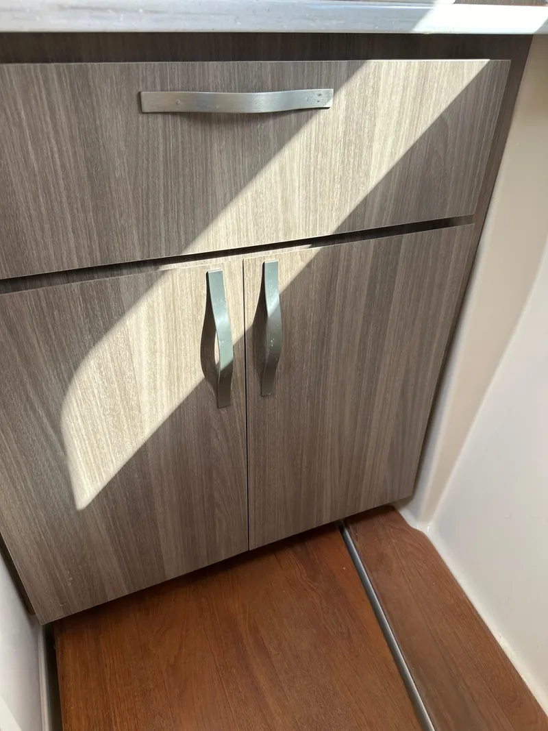 Slide: The Image of 2021 Regal 42 FXO interior cabinet with wood finish and modern handles. - 41