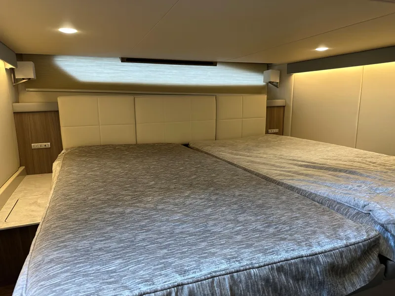Slide: The Image of Interior cabin of 2021 Regal 42 FXO yacht with modern bedding and ambient lighting. - 44