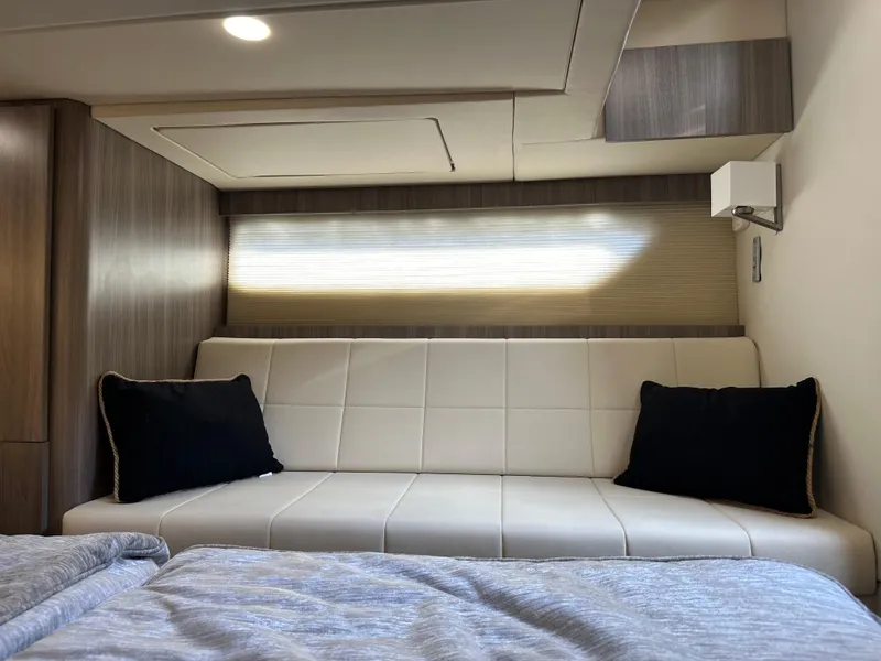 Slide: The Image of Interior of 2021 Regal 42 FXO yacht with modern sofa and bedding. - 45