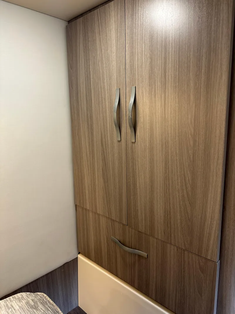 Slide: The Image of Wooden cabinet interior of 2021 Regal 42 FXO yacht, featuring sleek handles. - 47