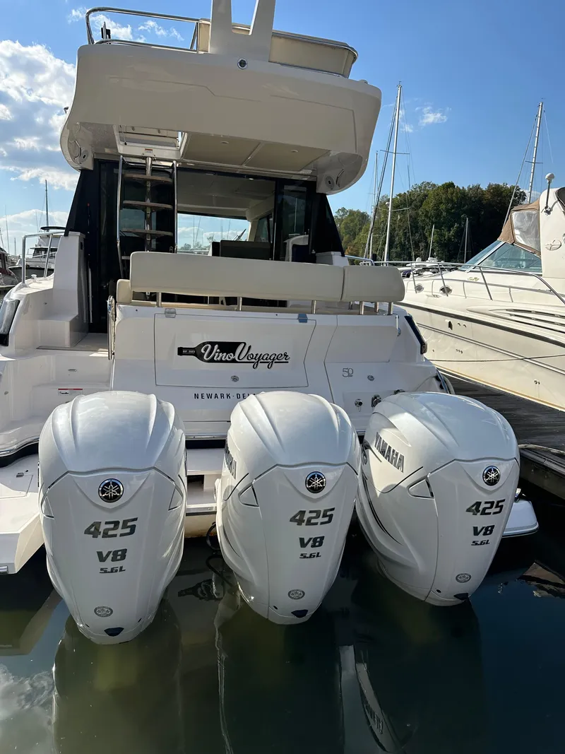 Slide: The Image of 2021 Regal 42 FXO yacht with triple Yamaha 425 V8 engines docked at marina. - 5