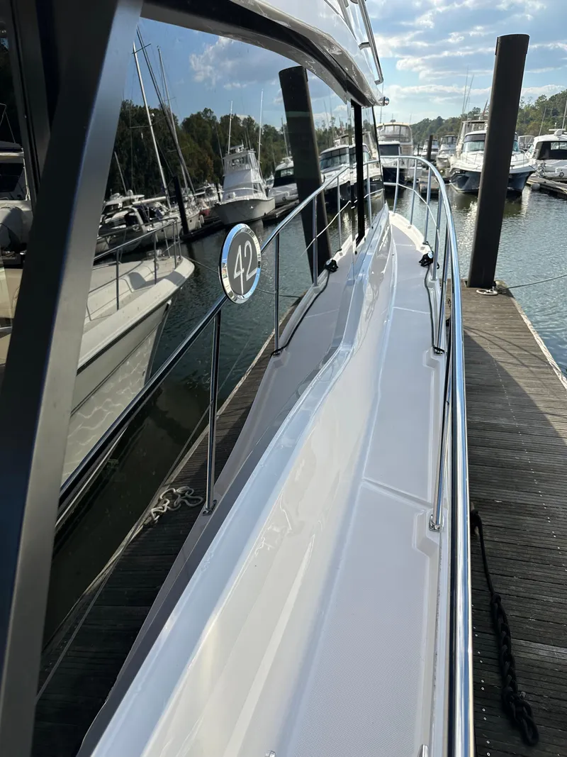 Slide: The Image of 2021 Regal 42 FXO yacht docked at marina, side view. - 6