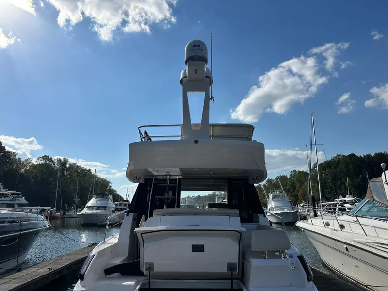 Slide: The Image of 2021 Regal 42 FXO yacht docked at marina under clear blue sky. - 9