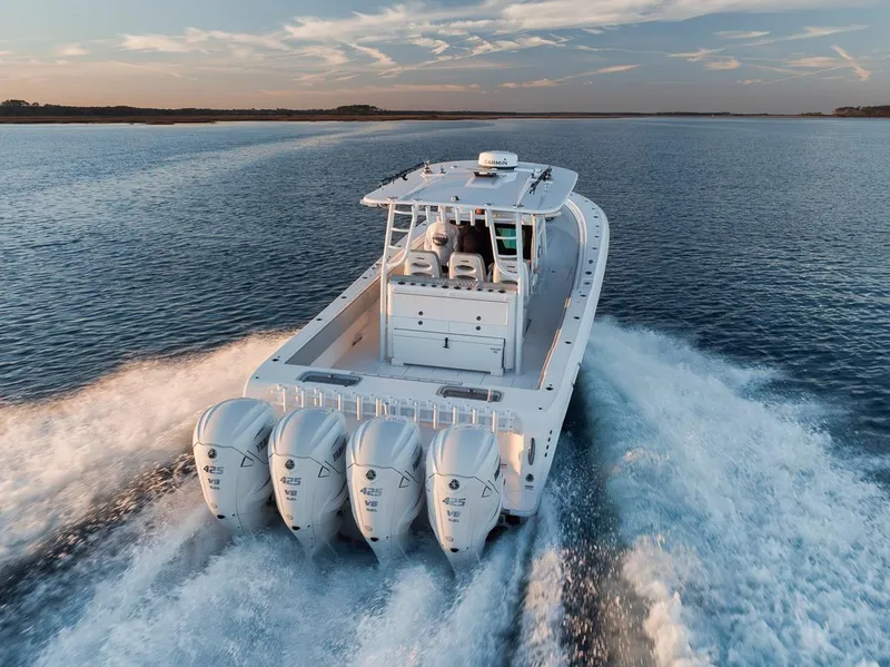 Slide: The Image of 2021 Contender 44 ST boat cruising on open water with four powerful engines. - 15