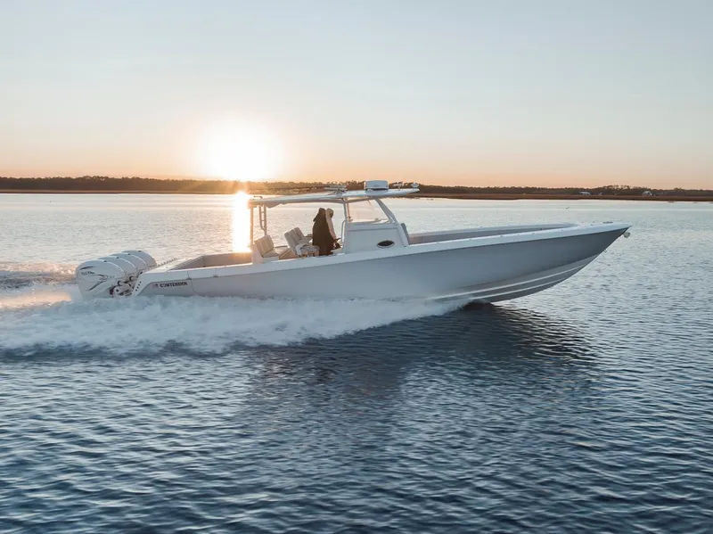 Slide: The Image of 2021 Contender 44 ST boat cruising at sunset on calm waters. - 16