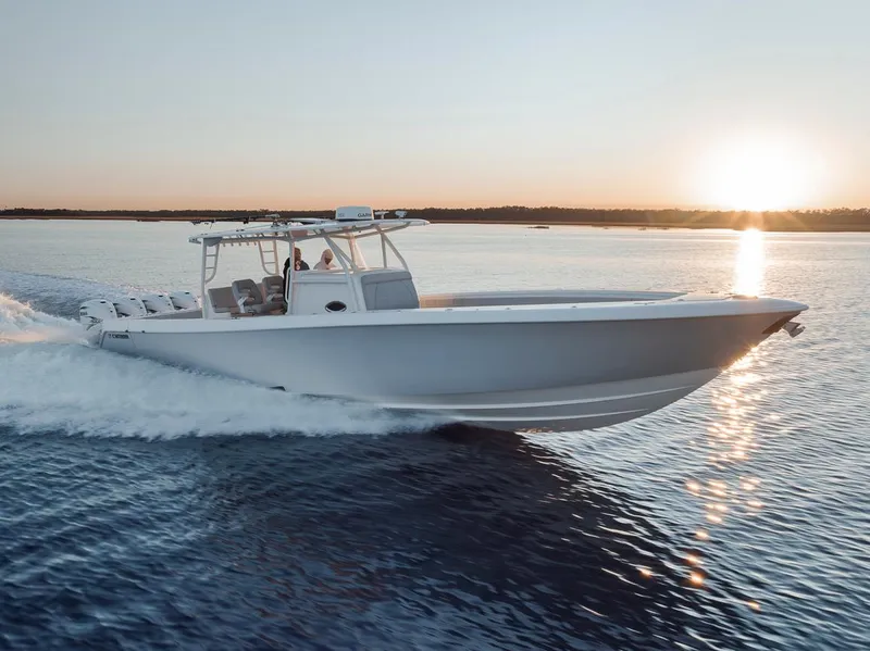 Slide: The Image of 2021 Contender 44 ST boat cruising at sunset on open water. - 17