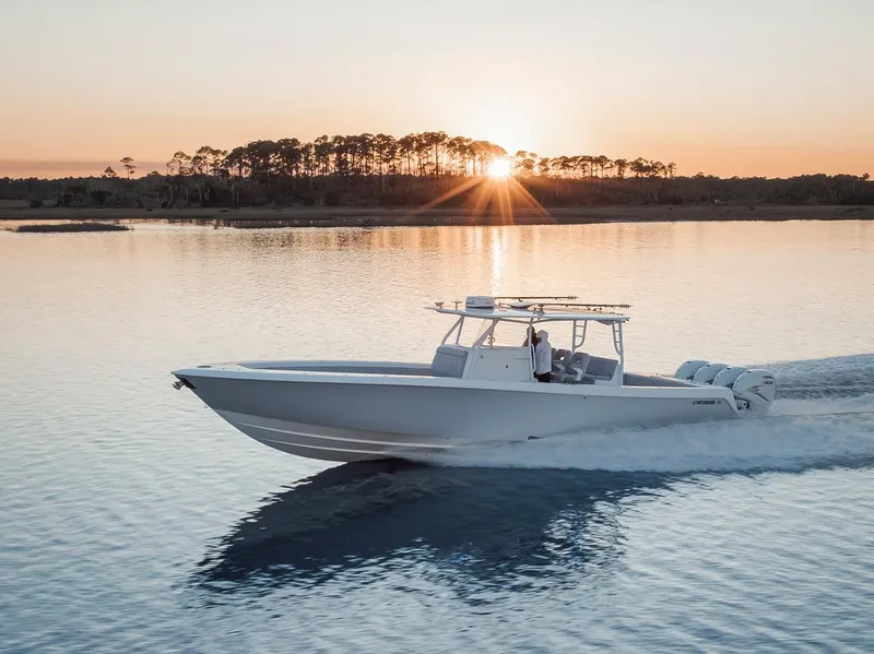 Slide: The Image of 2021 Contender 44 ST boat cruising at sunset on calm water. - 18
