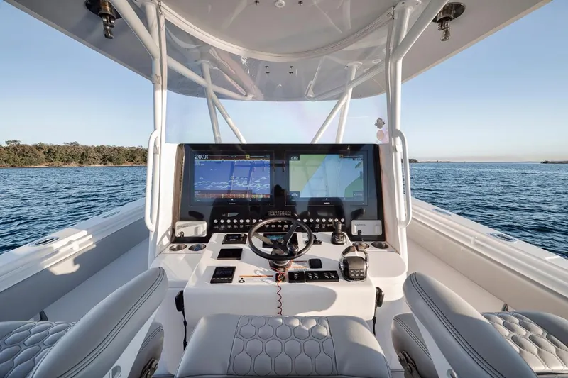 Slide: The Image of 2021 Contender 44 ST boat cockpit with advanced navigation system on open water. - 19