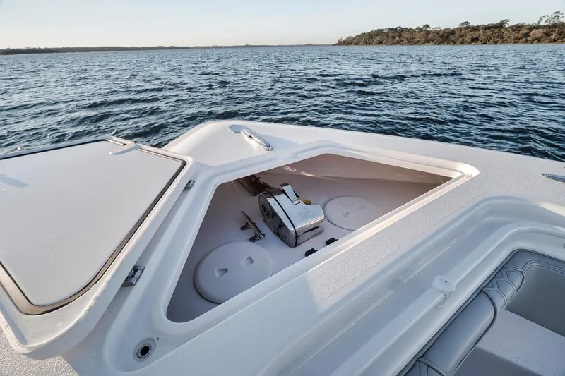 Slide: The Image of 2021 Contender 44 ST boat with open storage compartment on calm water. - 21