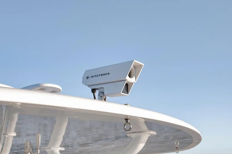 Slide: The Image of NiteTrack camera mounted on 2021 Contender 44 ST boat against clear blue sky. - 27