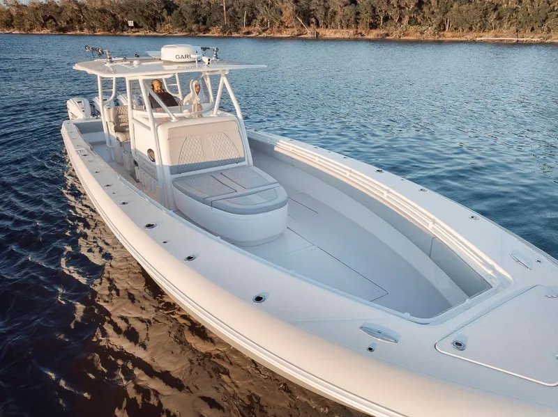 Slide: The Image of 2021 Contender 44 ST boat on calm water, showcasing sleek design and spacious deck. - 3