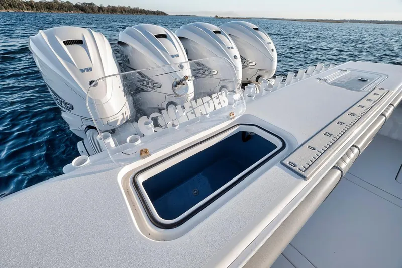 Slide: The Image of 2021 Contender 44 ST boat with four powerful outboard engines on open water. - 30