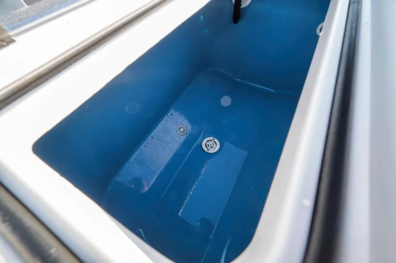 Slide: The Image of Contender 44 ST 2021 boat livewell, blue interior, close-up view. - 31