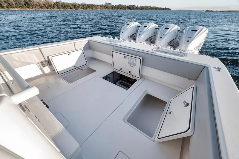 Slide: The Image of 2021 Contender 44 ST boat deck with open storage compartments and four outboard engines. - 32