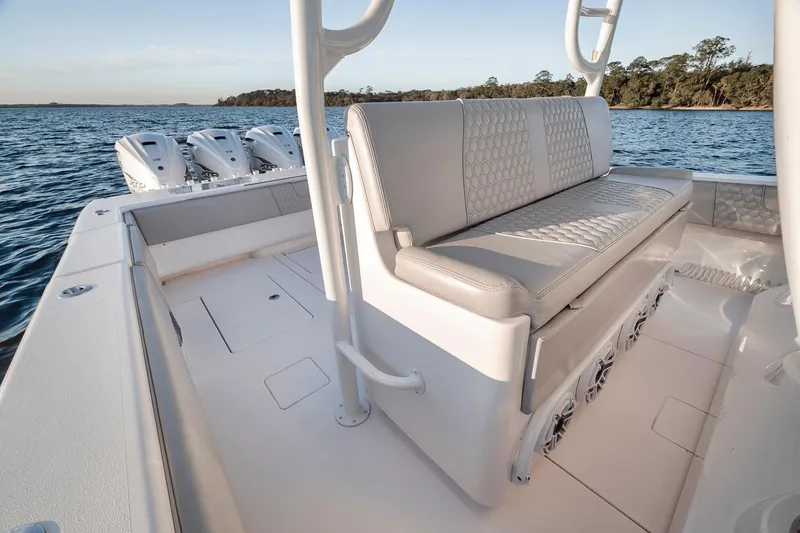 Slide: The Image of 2021 Contender 44 ST boat interior with seating, ocean view, and triple outboard engines. - 39
