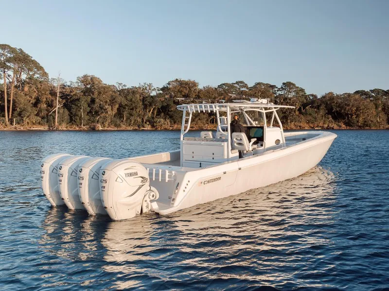 Slide: The Image of 2021 Contender 44 ST boat with four Yamaha outboard engines on a calm lake. - 4
