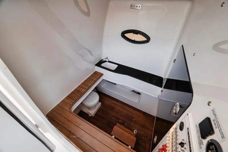 Slide: The Image of 2021 Contender 44 ST boat interior with wooden flooring, compact sink, and toilet. - 42