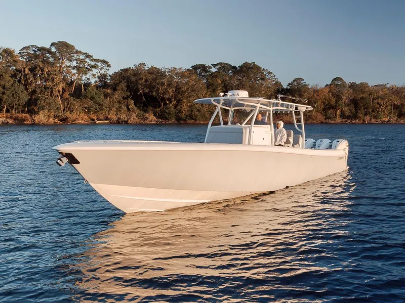 Slide: The Image of 2021 Contender 44 ST boat on calm water, surrounded by trees. - 5