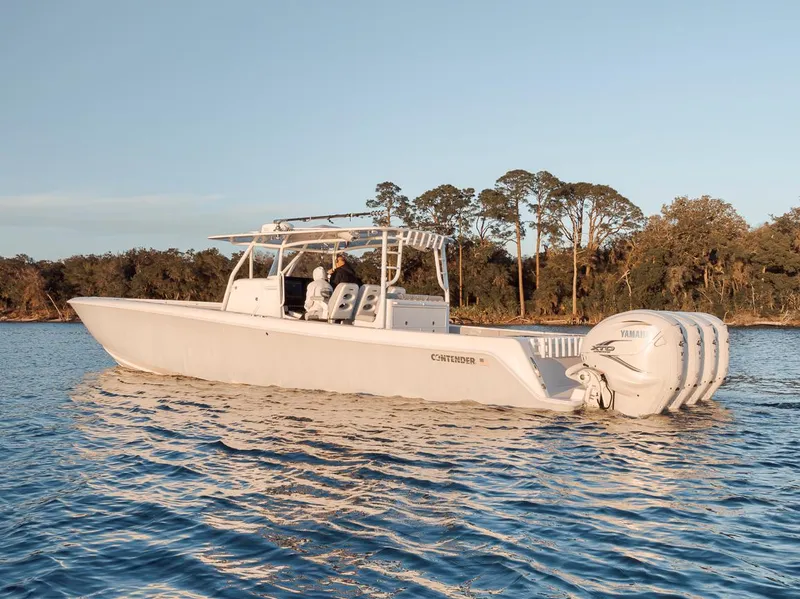 Slide: The Image of 2021 Contender 44 ST boat on calm water with scenic background. - 6