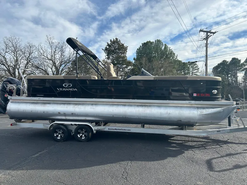 Slide: The Image of 2022 Veranda Relax VR25RC pontoon boat on trailer, parked outdoors. - 4