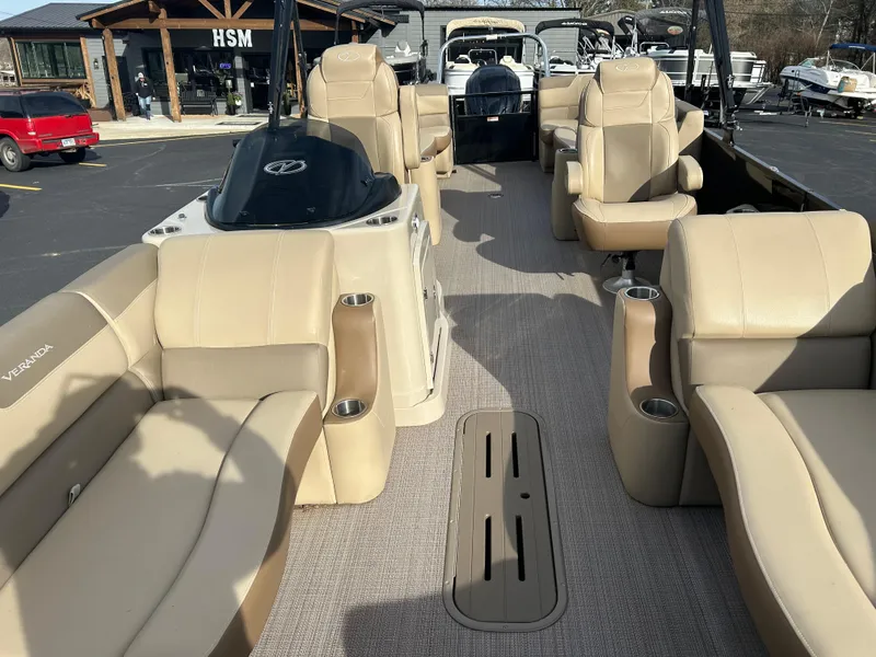 Slide: The Image of 2022 Veranda Relax VR25RC pontoon boat with beige seating and spacious interior layout. - 5