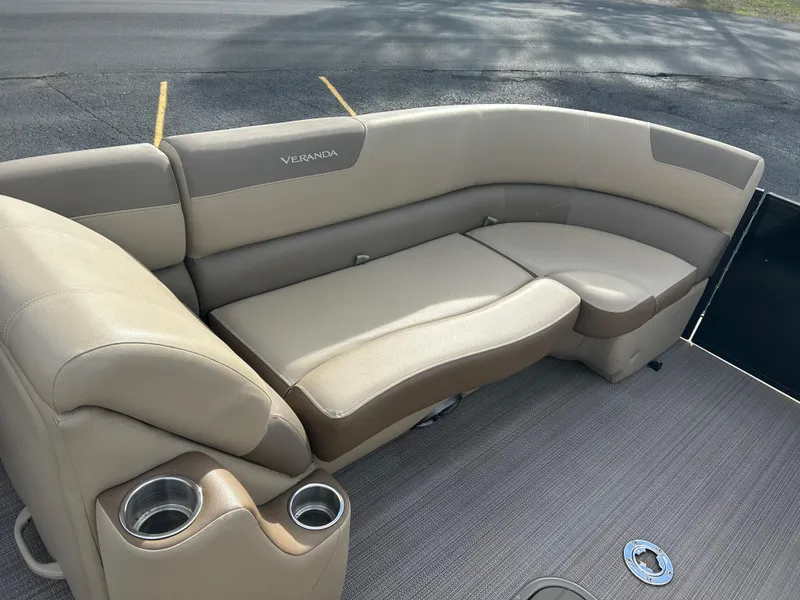 Slide: The Image of 2022 Veranda Relax VR25RC boat seating with beige upholstery and integrated cup holders. - 6